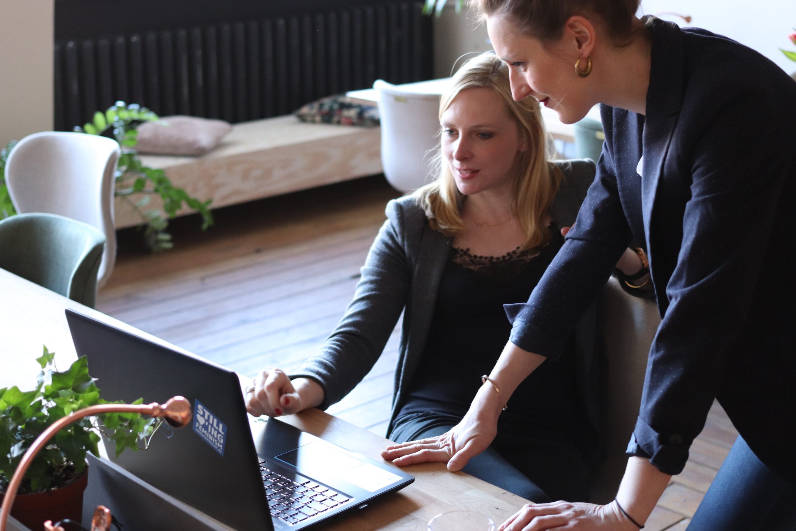 Two people looking at a computer of a successful press release